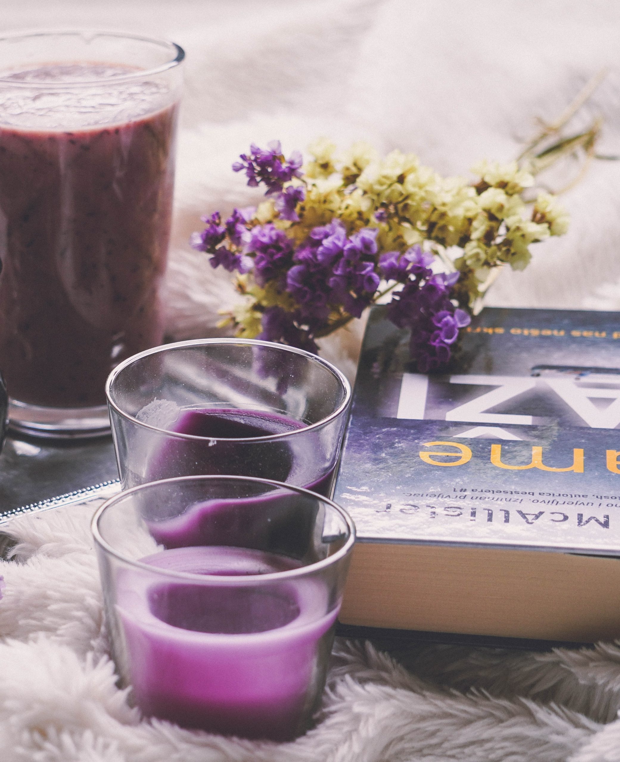 Book with candles, flowers and a smoothie