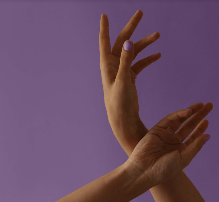 Hands in the air with purple background